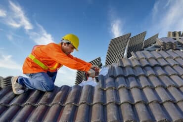 Happy homeowner with new roof - affordable financing options available